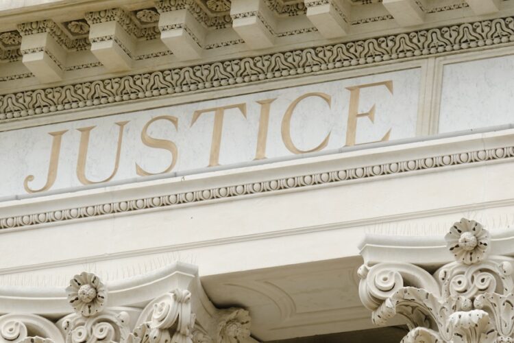 Justice word engraved Justice word engraved on the pediment of the courthouse
